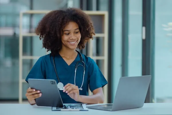 Healthcare professional reviewing information on a tablet — document translation services by Loop Translate