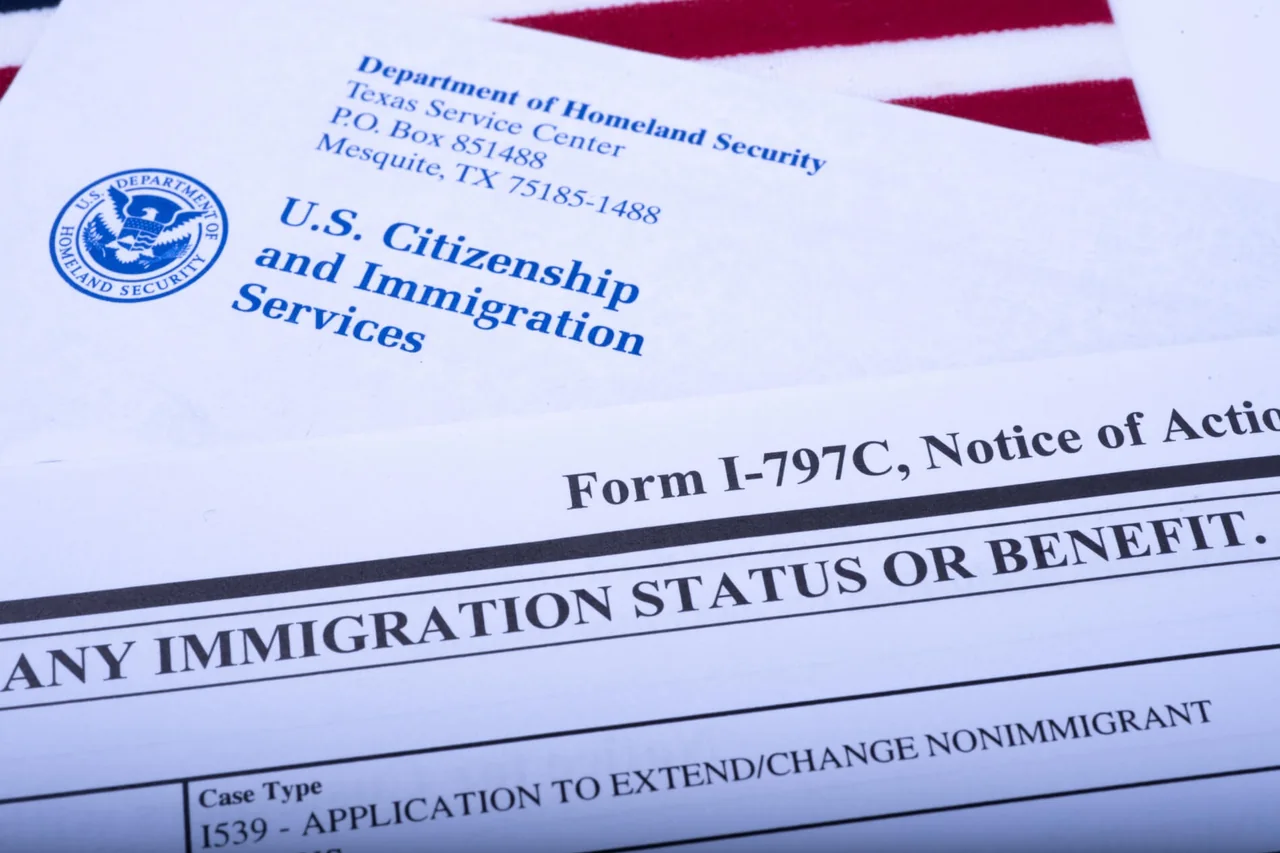 USCIS correspondence and a notice of action on a United States flag — document translation services by Loop Translate